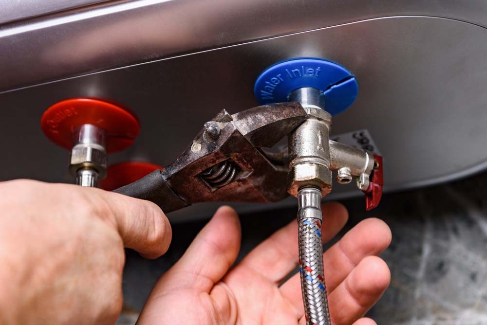 Bell Plumbing technician installing a new water heater