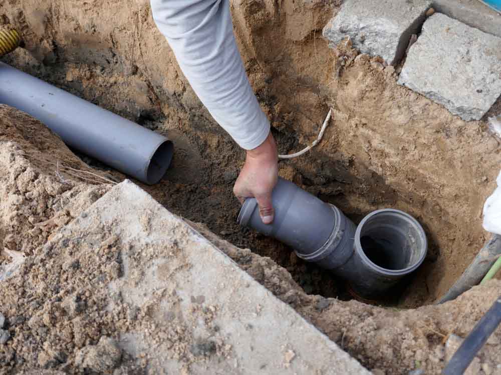 Bell Plumbing technician working on sewer repairs