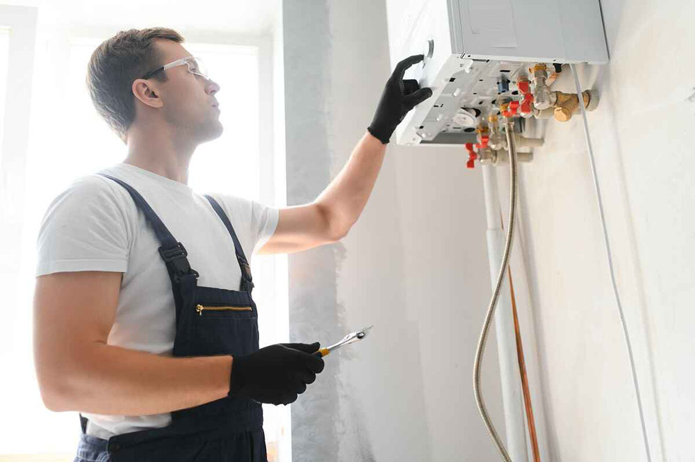 technician installing a new water heating system