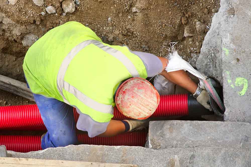 technicians repairing a sewer lateral